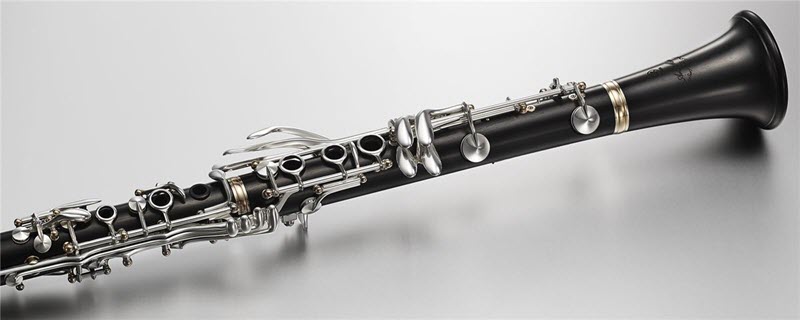 Clarinet finger keys Clarinet laying on a flat surface.