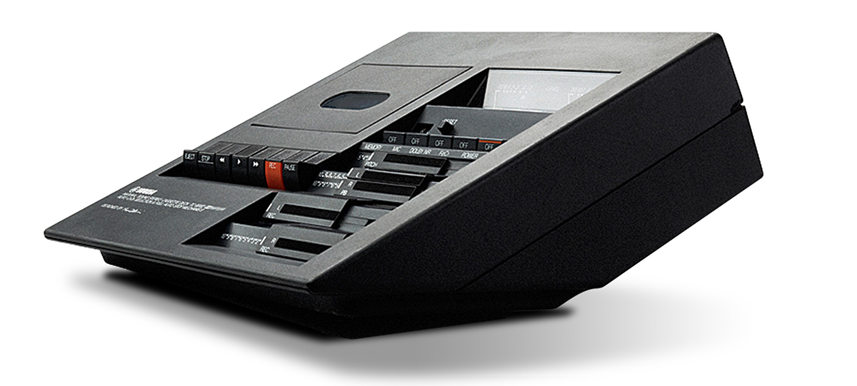 Hifi History Body Image 3 An image of an old-fashioned cassette player. It is designed so that it sits at a 30-degree angle up form the surface it's placed on.