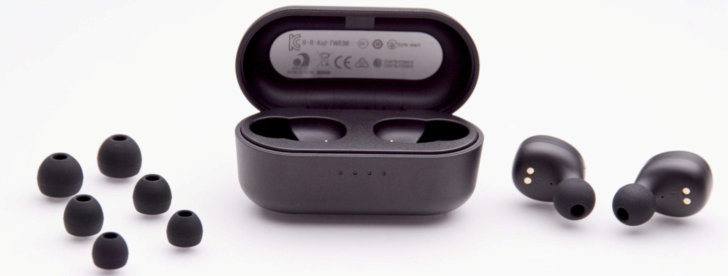 Eartips-1900 A small black earbuds case in middle opened to show elements. On right are the two electronic earbuds and on right are the three pairs of sized ear tips to fit on buds.